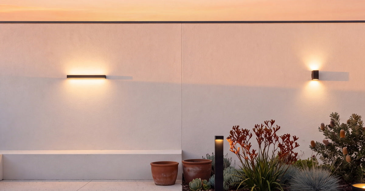 Courtyard at sunset lit by LumePorch wall, bollard and garden lights