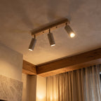 3-Head Travertine-Look Spotlight Ceiling Light glowing on a ceiling at night