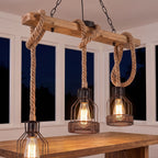Wood beam and hemp rope pendant light over a sunroom table at night