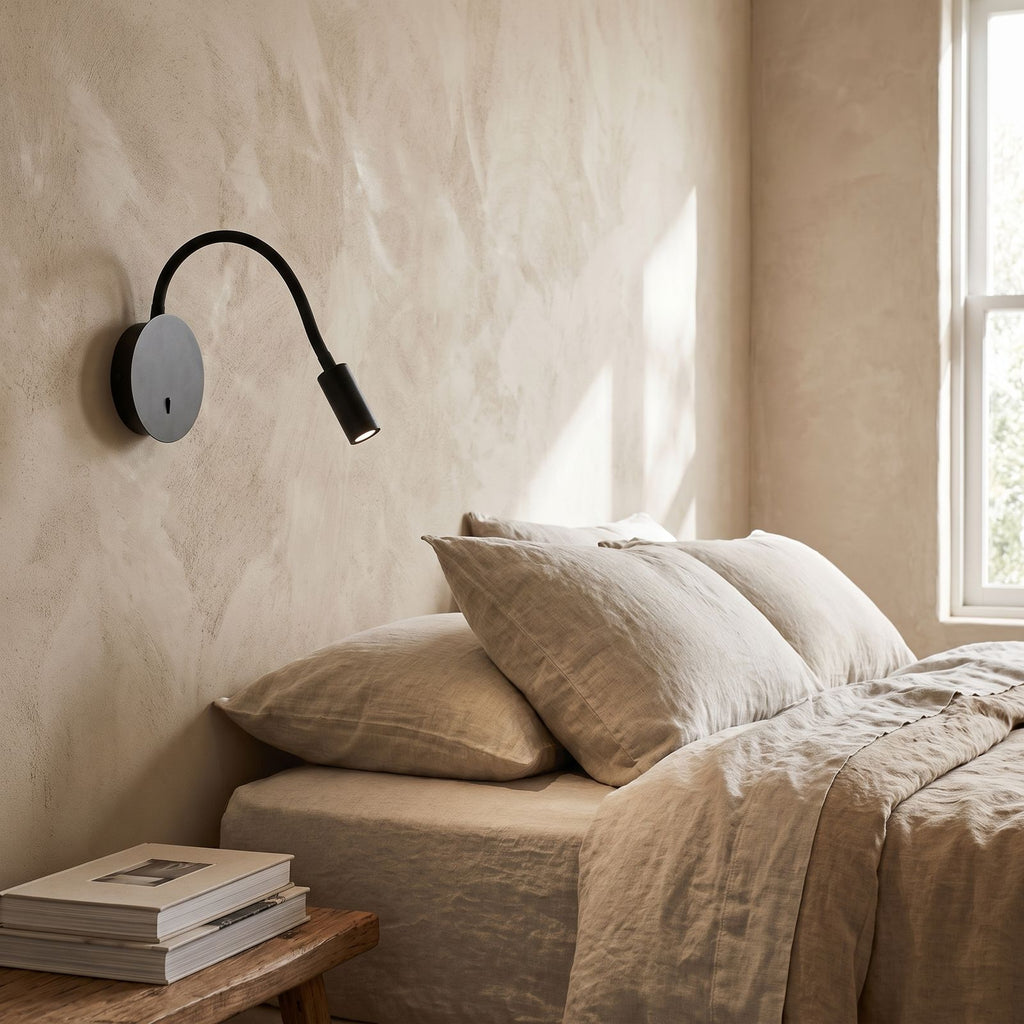 360-Degree Adjustable Silicone LED Wall Light on a bedroom wall beside the bed