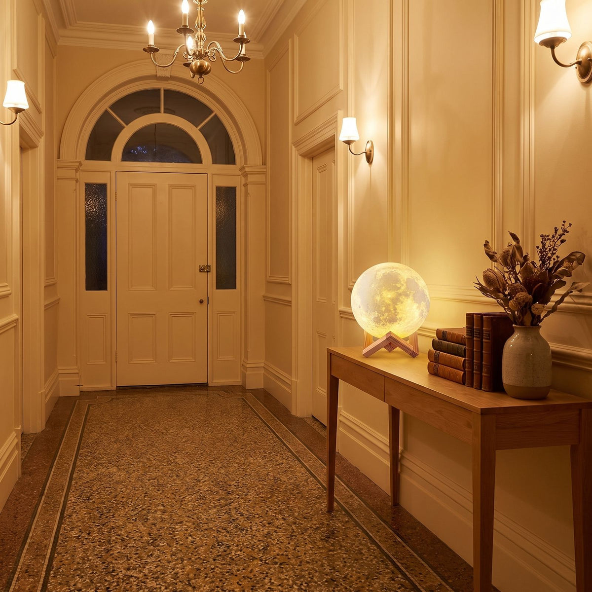 The 3D moon lamp in 18 cm on a timber console in a heritage entrance hallway in the evening