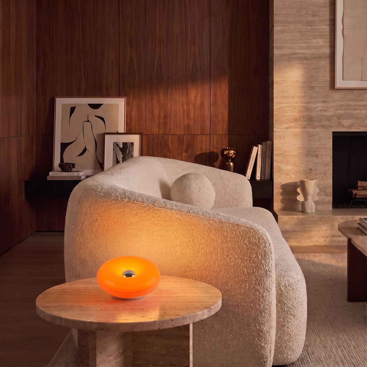 Acrylic Donut Rechargeable LED Table Lamp in orange on a stone side table beside a sofa in a classic living room