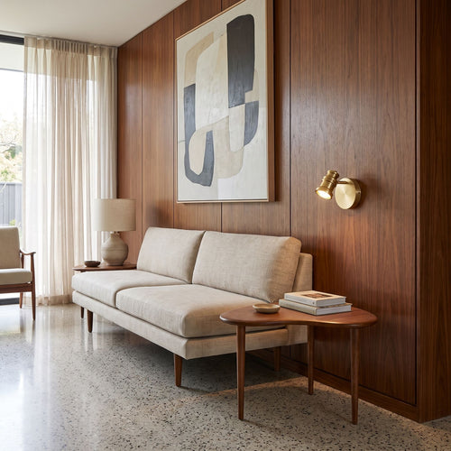 Adjustable Brass Spotlight Dimmable LED Wall Light beside a sofa in a living room