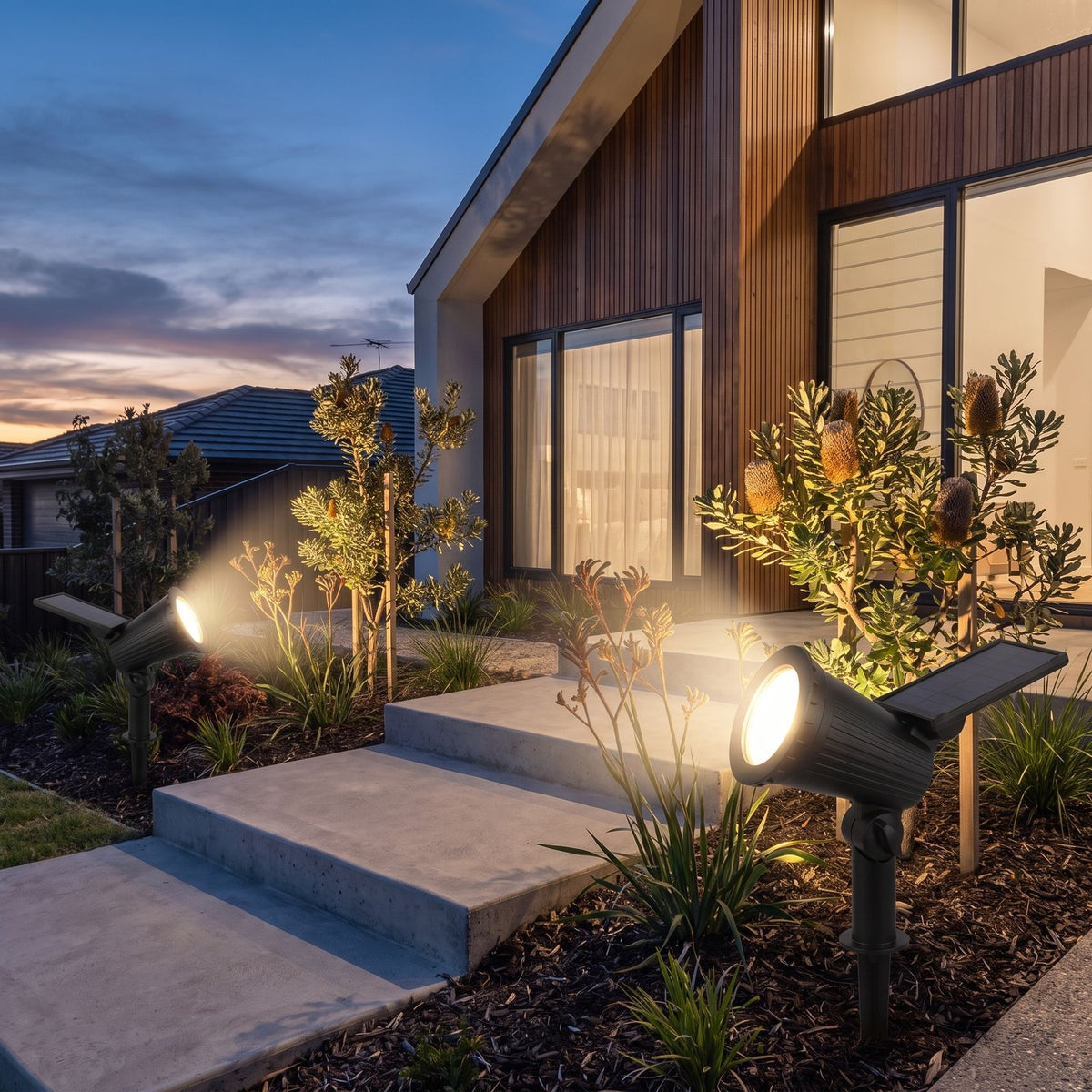 Solar spotlight garden light beside front entry steps