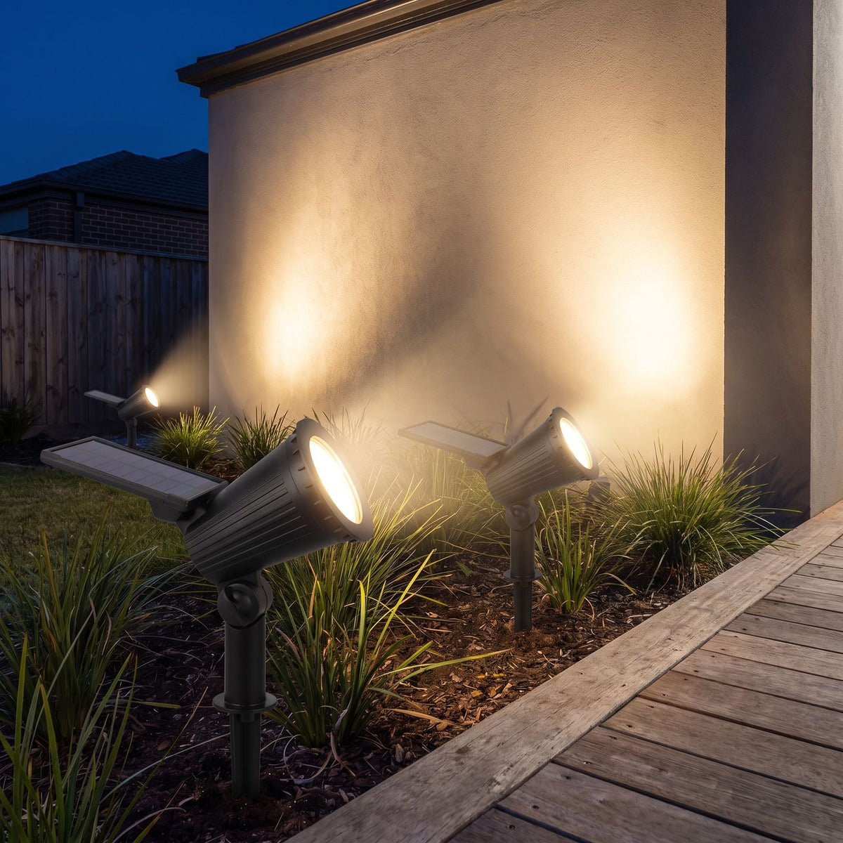 Solar spotlight garden light beside a timber deck at night