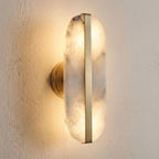 Alabaster and Brass Wall Sconce, close view at 45 degrees on a plaster wall
