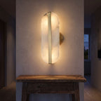Alabaster and Brass Wall Sconce in a hallway above a timber console
