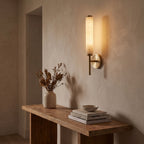 Alabaster Candle Brass Wall Sconce in a hallway above a timber console