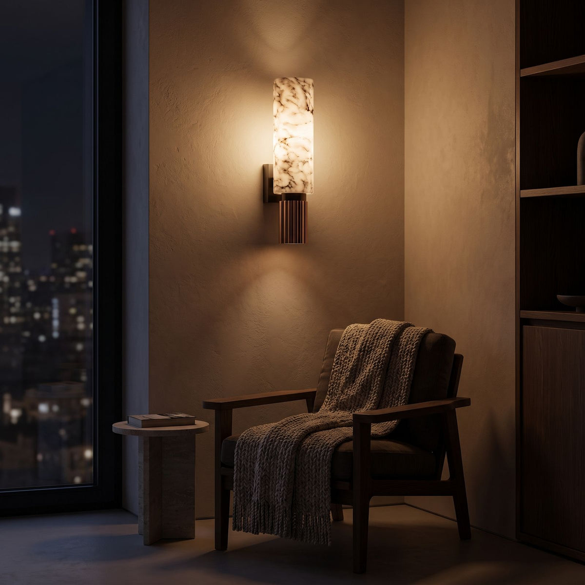 Alabaster Cylinder and Fluted Copper Wall Light beside an armchair at night