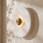 Alabaster Disc Wall Light on a plaster wall, angled close view