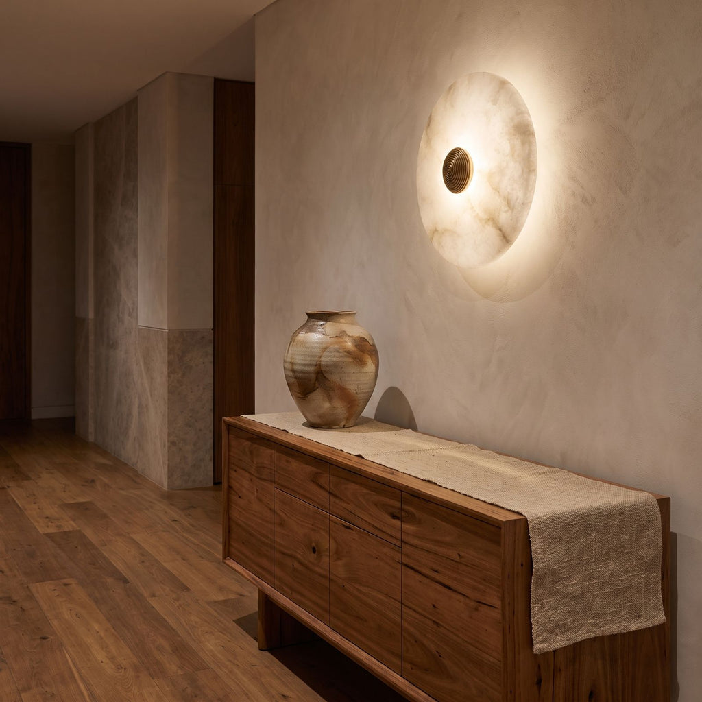 Alabaster Disc Wall Light above a timber console in an entry hallway