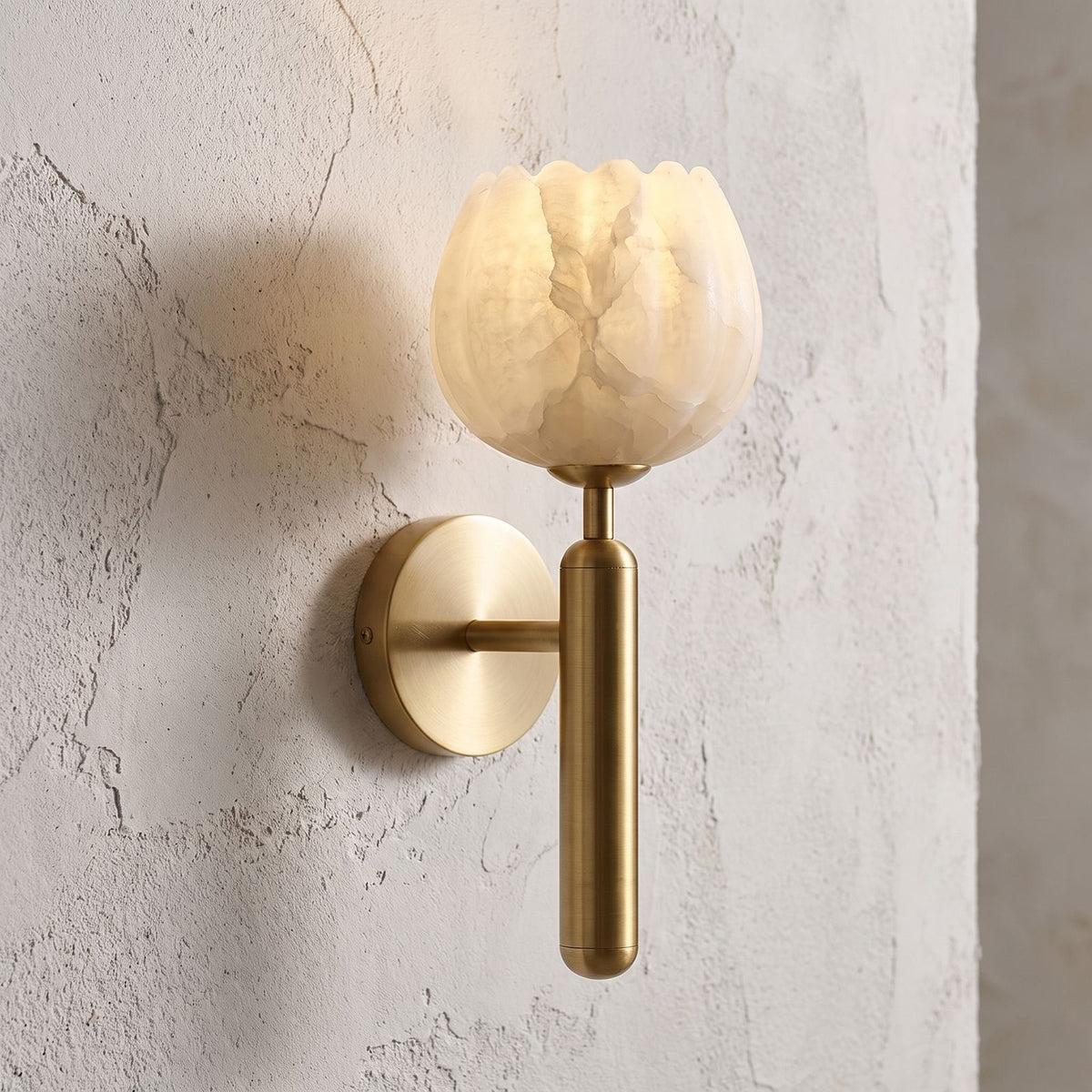 Marble Flower Petal Brass Wall Sconce, close view at 45 degrees on a plaster wall