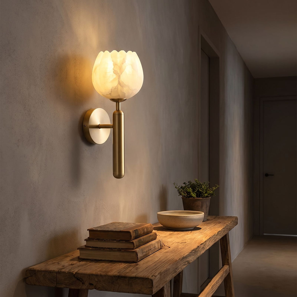 Marble Flower Petal Brass Wall Sconce in a hallway above a timber console