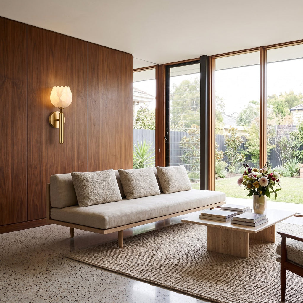 Marble Flower Petal Brass Wall Sconce on a walnut wall beside a living room sofa
