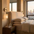 Alabaster-Look Glass Cylinder Drop Wall Light beside a bed in a bedroom