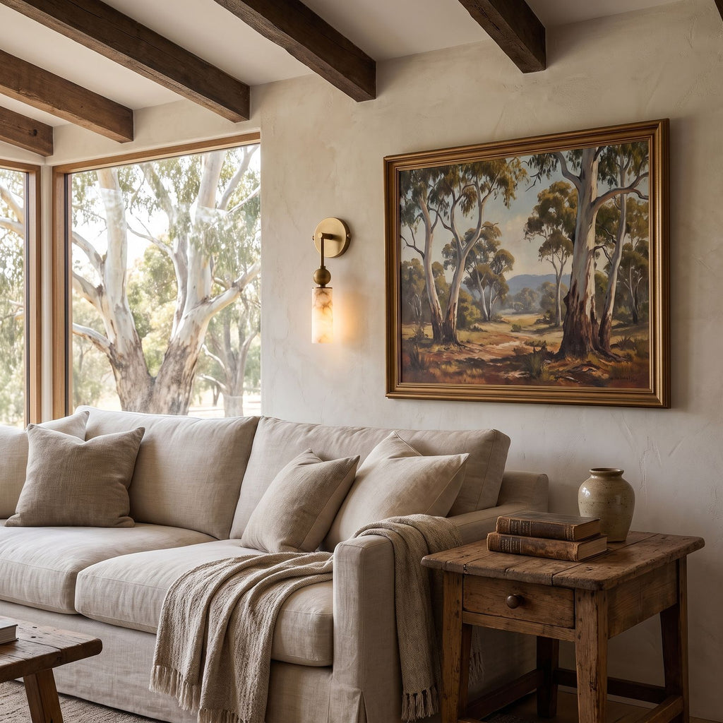 Alabaster-Look Glass Cylinder Drop Wall Light beside a sofa in a living room