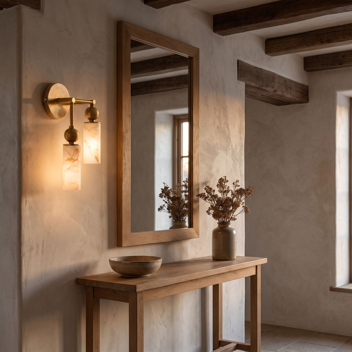 Alabaster-Look Glass Cylinder Drop Wall Light, 2 heads with the lower cylinder on the left, in brass, in an entry hall