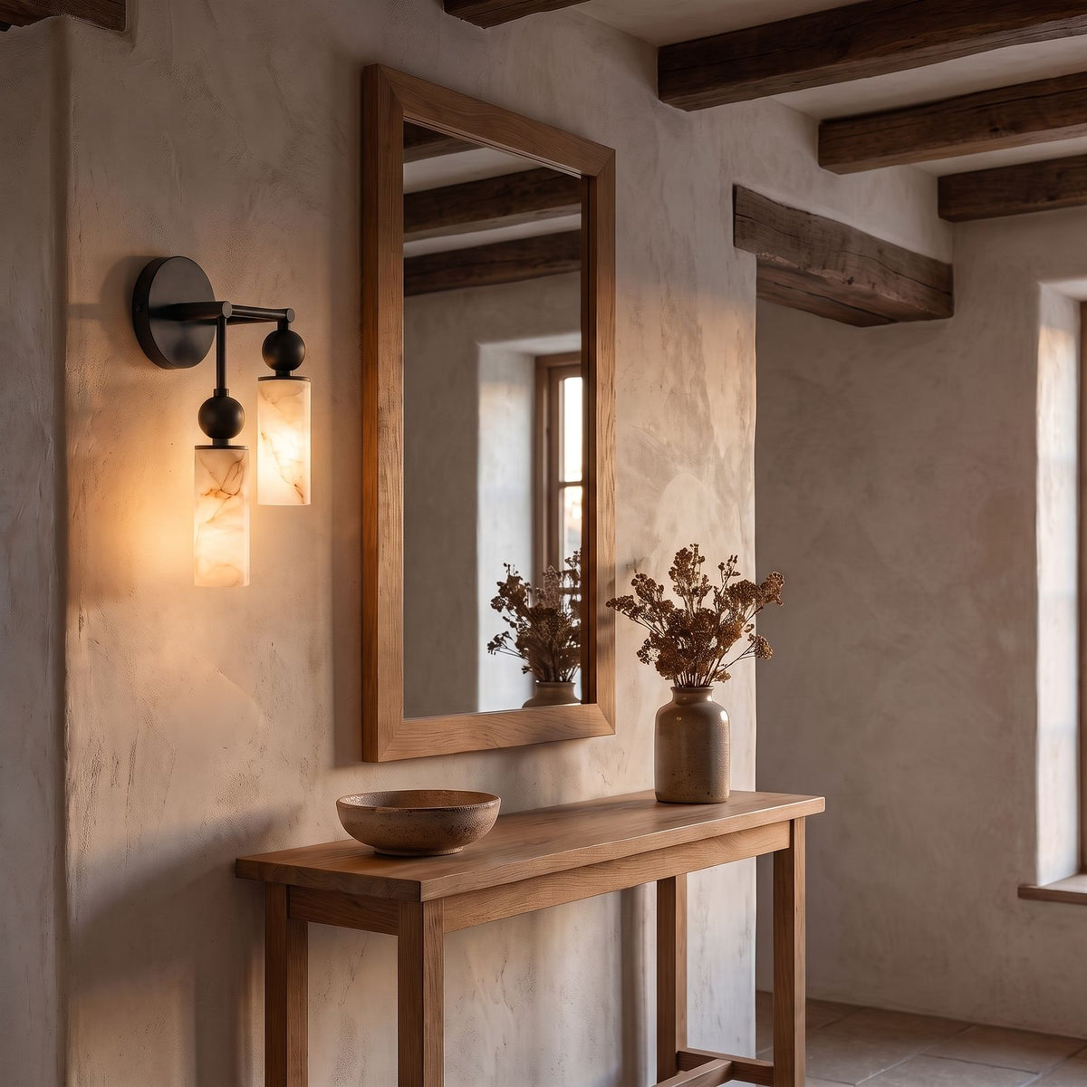 Alabaster-Look Glass Cylinder Drop Wall Light, 2 heads with the lower cylinder on the left, in black, in an entry hall