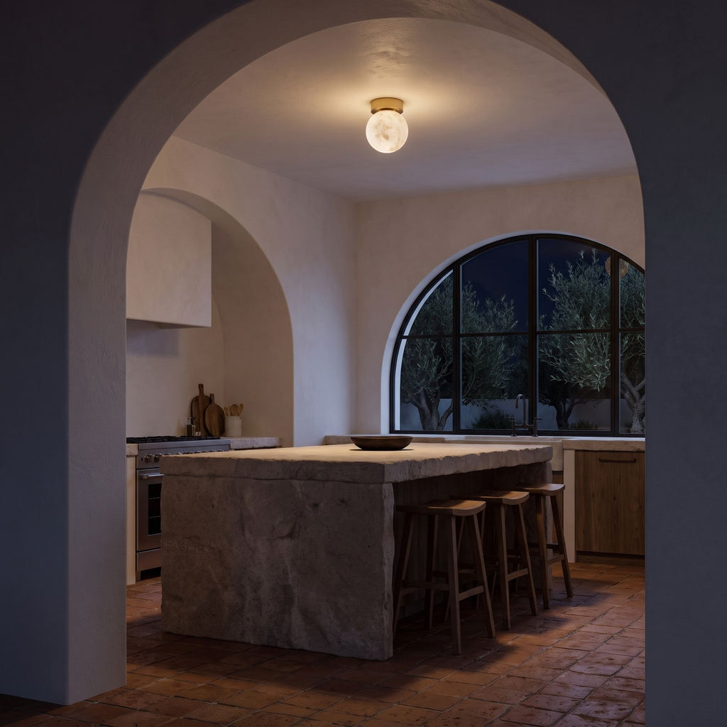 Alabaster Marble Globe Flush Mount Ceiling Light above a kitchen island at night