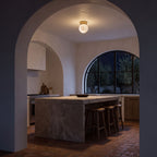 Alabaster Marble Globe Flush Mount Ceiling Light above a kitchen island at night
