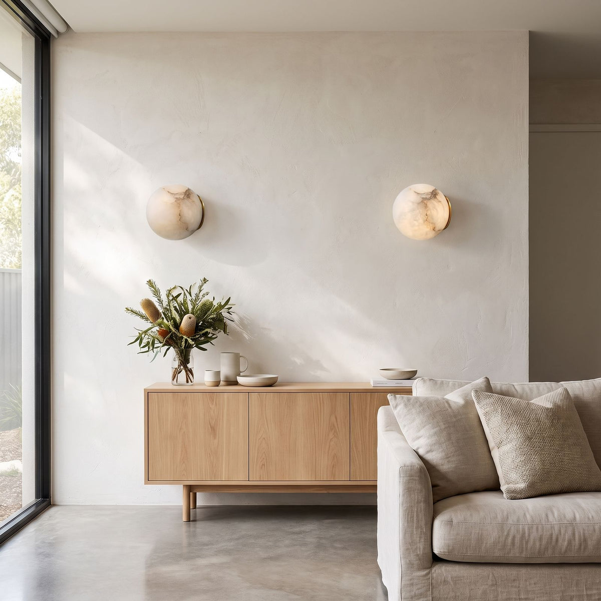 Alabaster Orb Wall Light with Gold Base in a pair on a wall of an Australian home