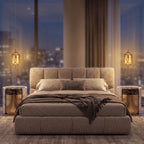 A pair of amber glass capsule pendants either side of the bed in a luxury apartment bedroom at night