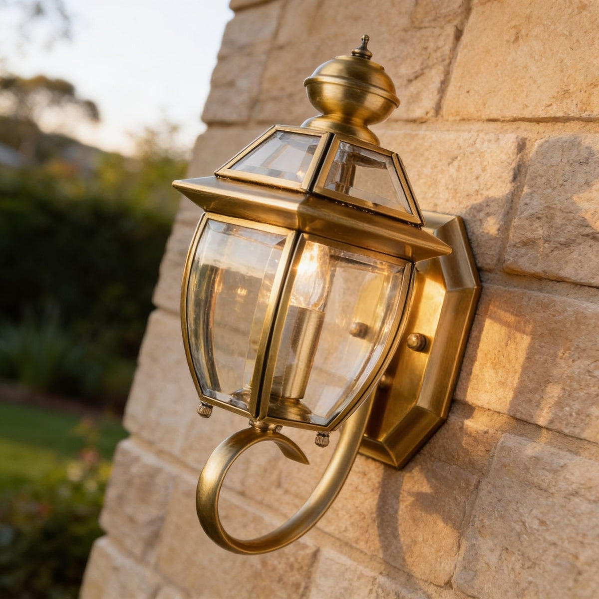 Antique Brass Glass Outdoor Wall Lantern on a sandstone wall, angled close view
