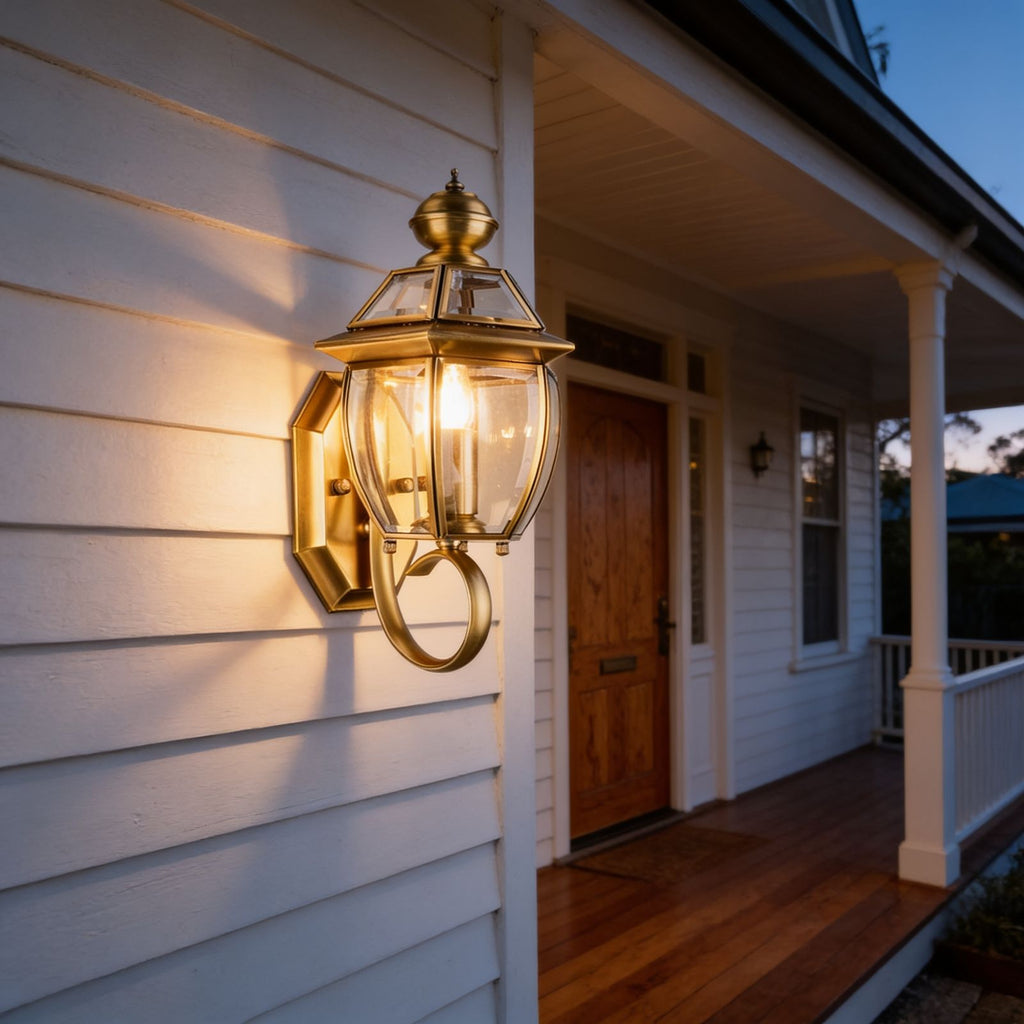 Antique Brass Glass Outdoor Wall Lantern glowing on a porch at dusk