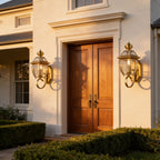 A pair of Antique Brass Glass Outdoor Wall Lanterns either side of a double entry door