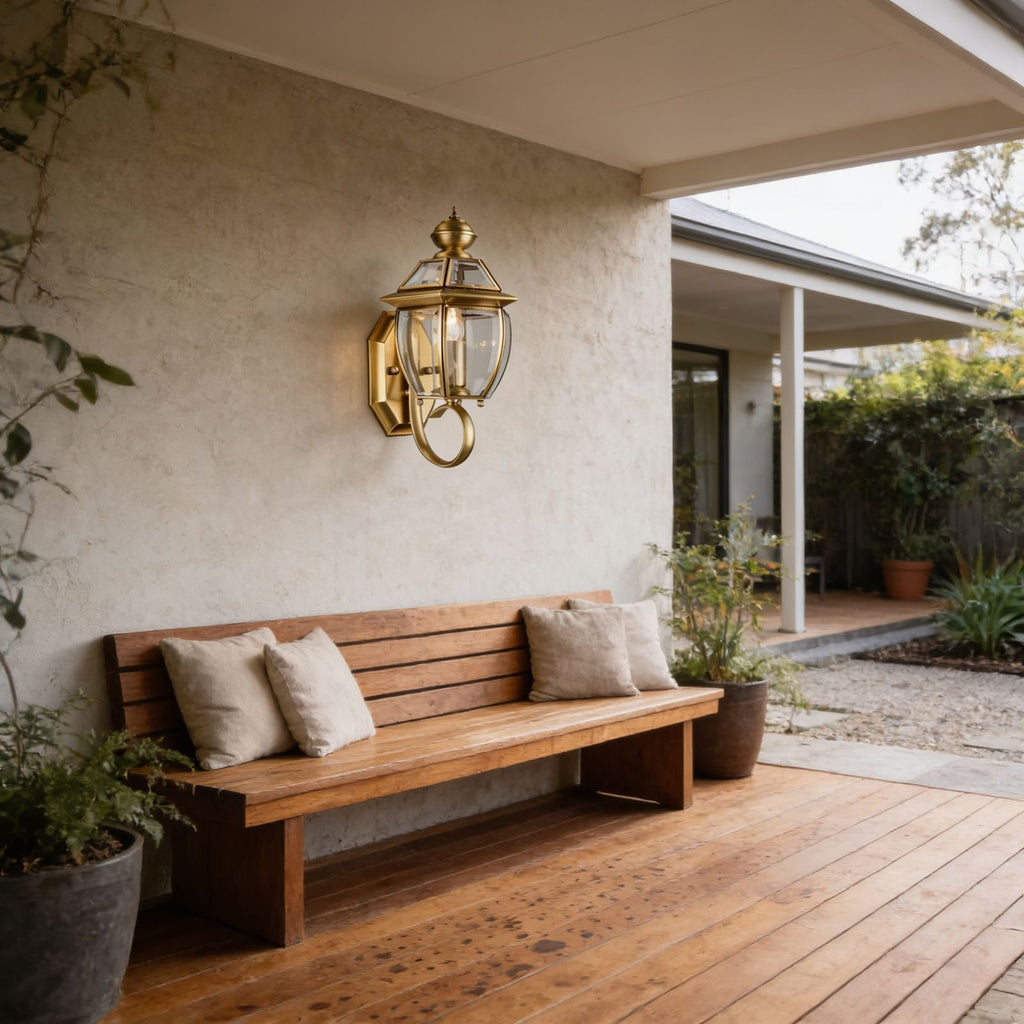 Antique Brass Glass Outdoor Wall Lantern above a bench on a covered patio