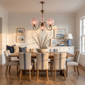 Antique Brass Scroll Arm Glass Globe Chandelier above a dining table at golden hour