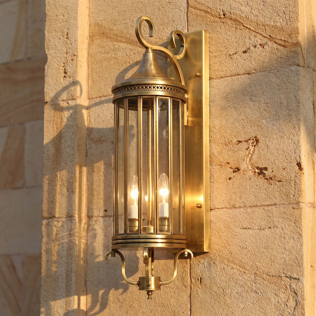 Arabian Style Brass and Glass Outdoor Wall Lantern, close view at 45 degrees on a stone wall