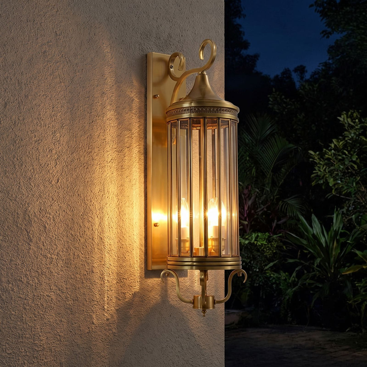 Arabian Style Brass and Glass Outdoor Wall Lantern glowing on a garden wall at night