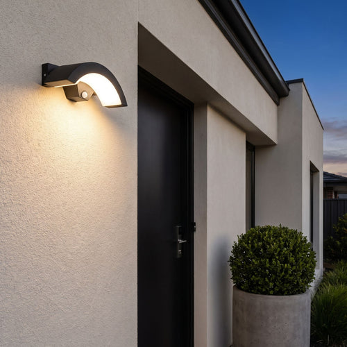 Arc Motion Sensor Outdoor Wall Light beside a front door at dusk