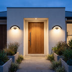 A pair of Arc Motion Sensor Outdoor Wall Lights either side of a timber front door
