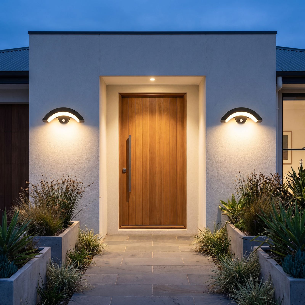 A pair of Arc Motion Sensor Outdoor Wall Lights either side of a timber front door