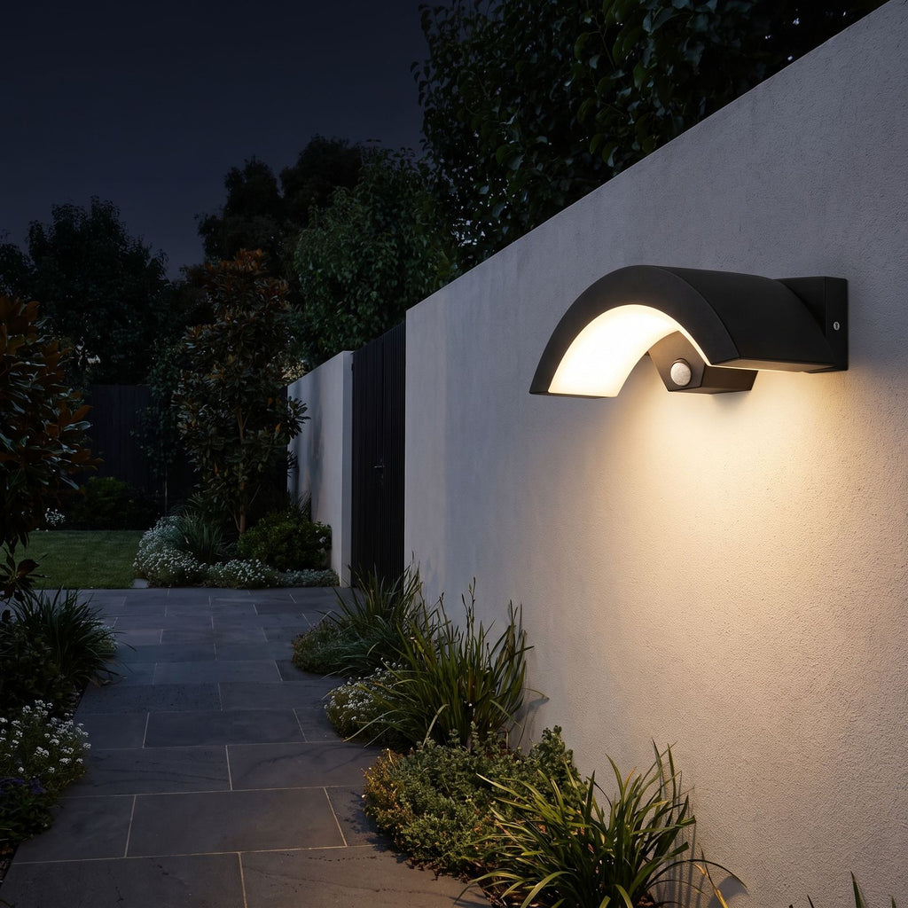 Arc Motion Sensor Outdoor Wall Light on a garden path wall at night