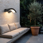Arc Motion Sensor Outdoor Wall Light above a courtyard bench