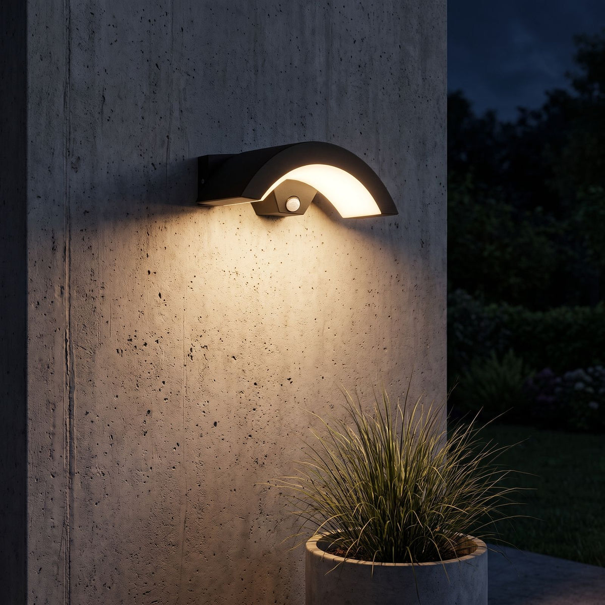 Arc Motion Sensor Outdoor Wall Light lighting a concrete wall at night