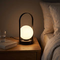 Arch Frame Frosted Glass Globe Table Lamp on a bedside table