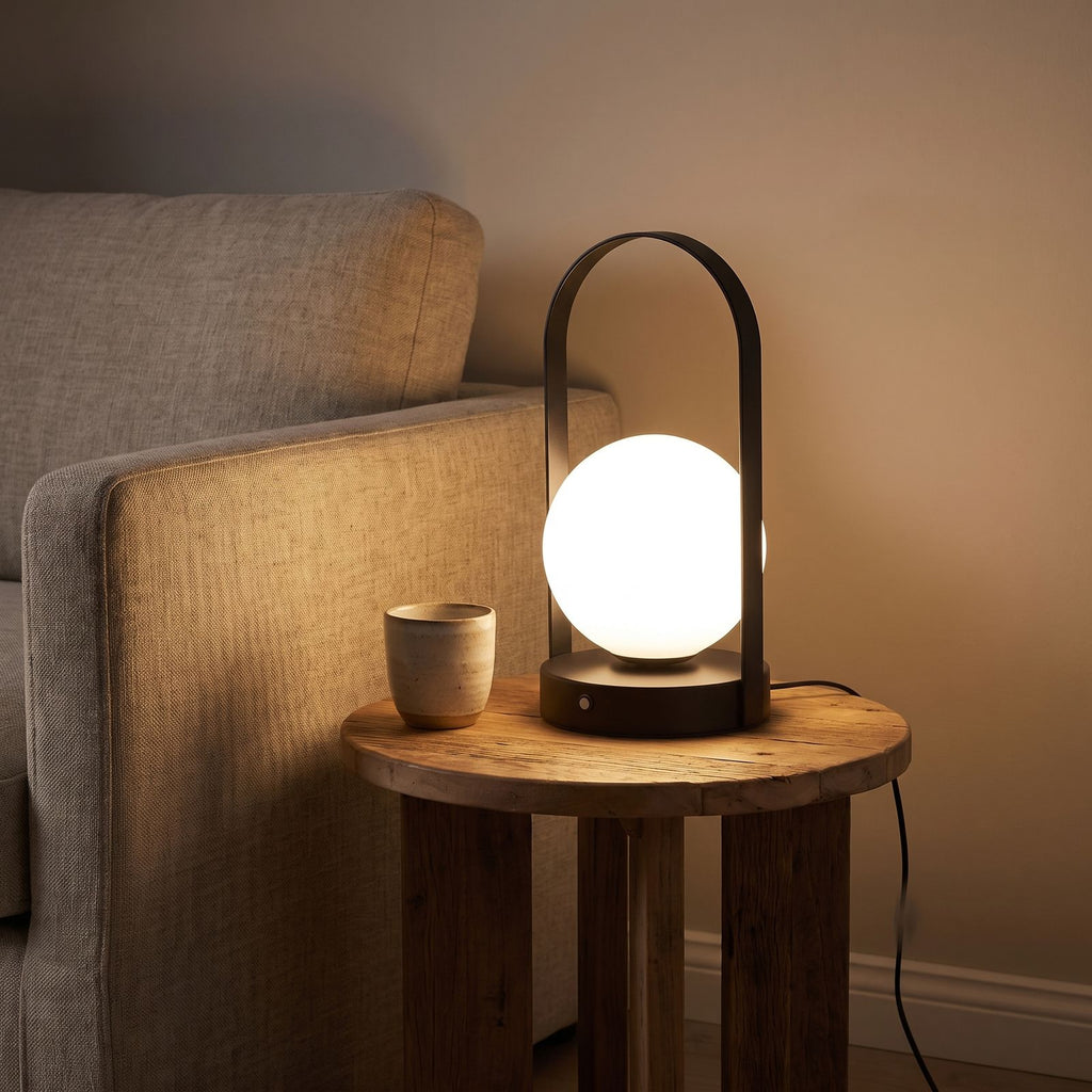 Arch frame frosted glass globe table lamp on a side table beside a sofa