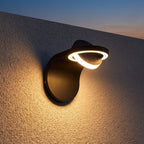 Arched Metal and Acrylic Outdoor Wall Light on a porch wall at dusk