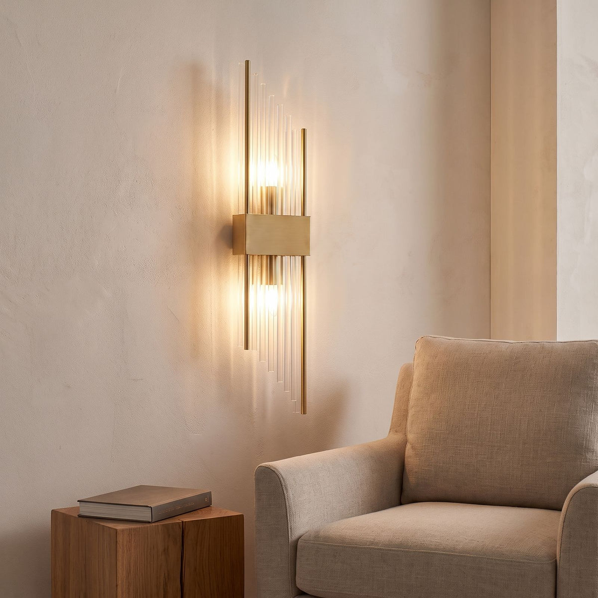Crystal glass rod wall light above an armchair in a reading corner