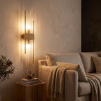 Crystal glass rod wall light beside a living room sofa at night