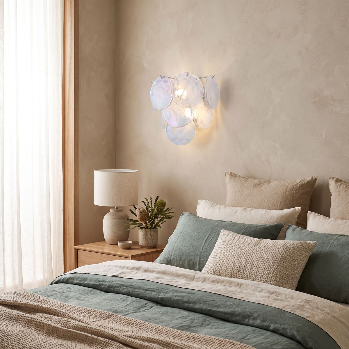 Art Deco Fan Textured Glass Wall Light on a bedroom wall beside the bed