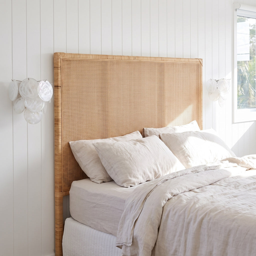 A pair of Art Deco Fan Textured Glass Wall Lights either side of a rattan bedhead