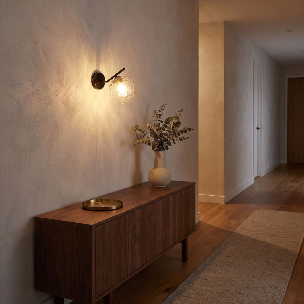 Art Deco Glass Ball Up Down Wall Sconce in a hallway above a timber console