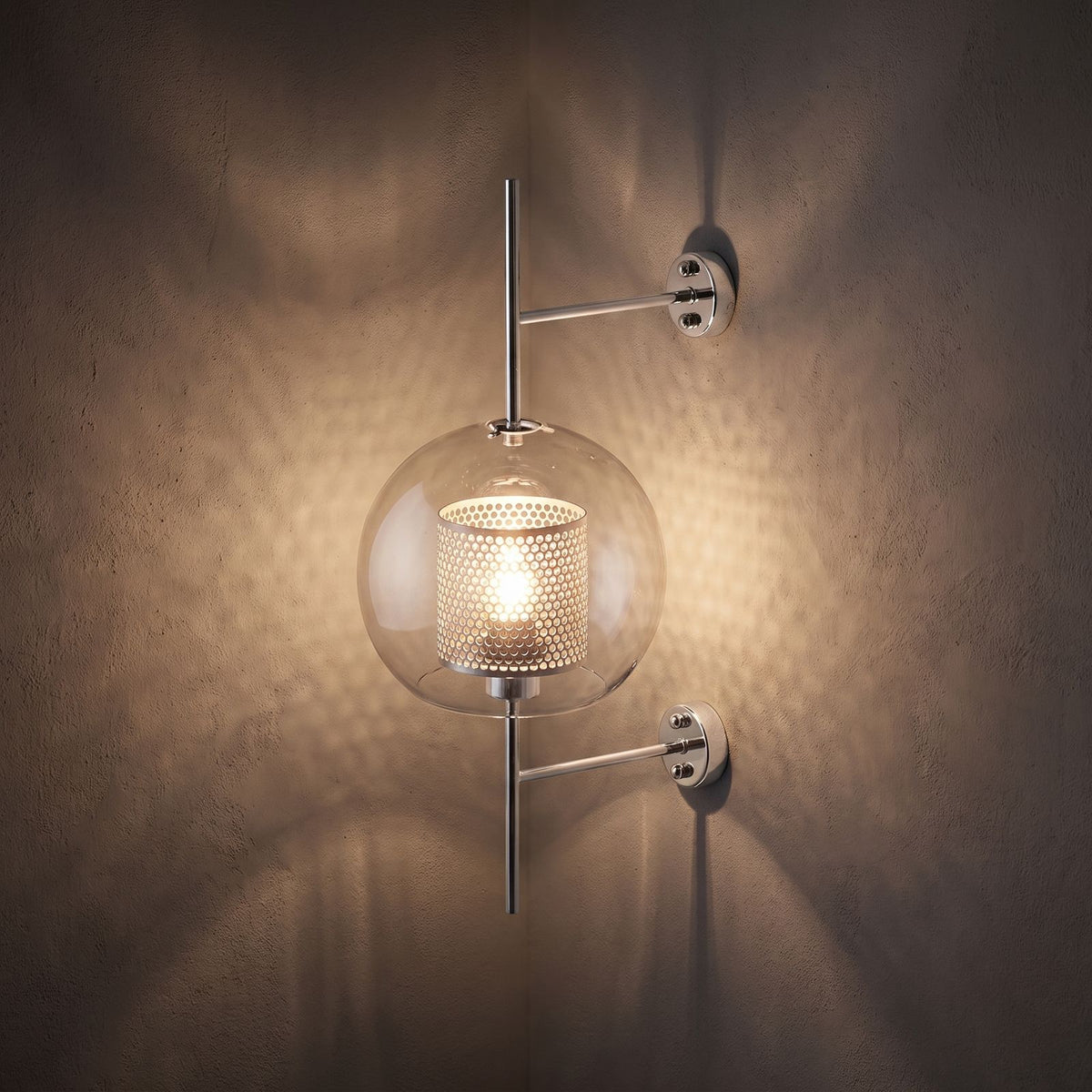 Art Deco Metal Rod and Clear Glass Up Down Wall Light glowing on a plaster wall at night