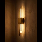 Asymmetric Linear LED Wall Sconce glowing on a plaster wall at night