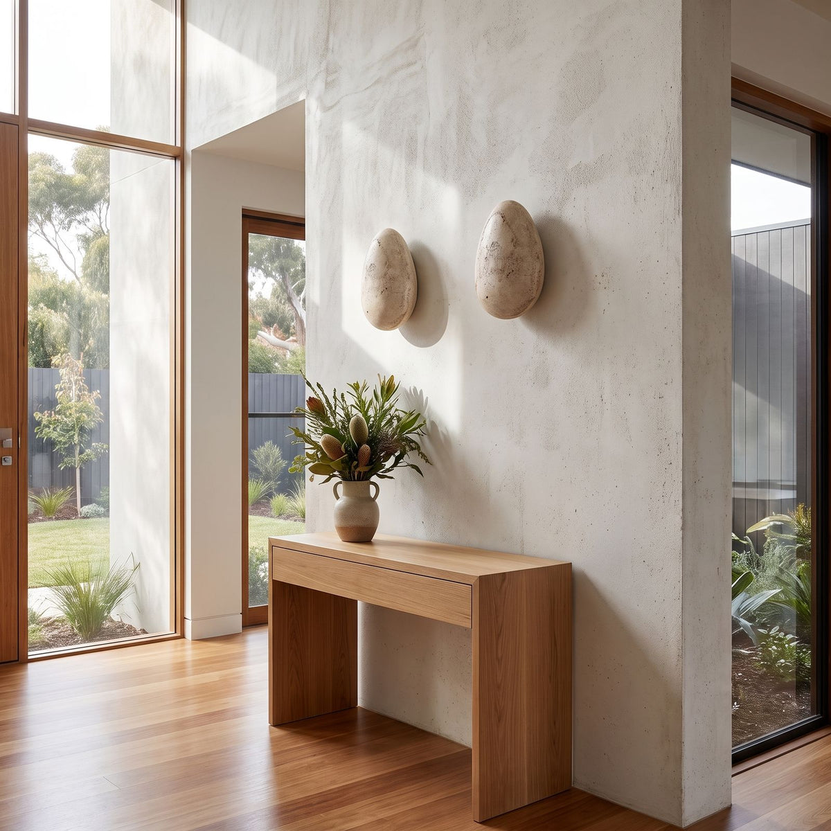 Backlit Floating Pebble Marble Wall Light in a pair on a wall of an Australian home